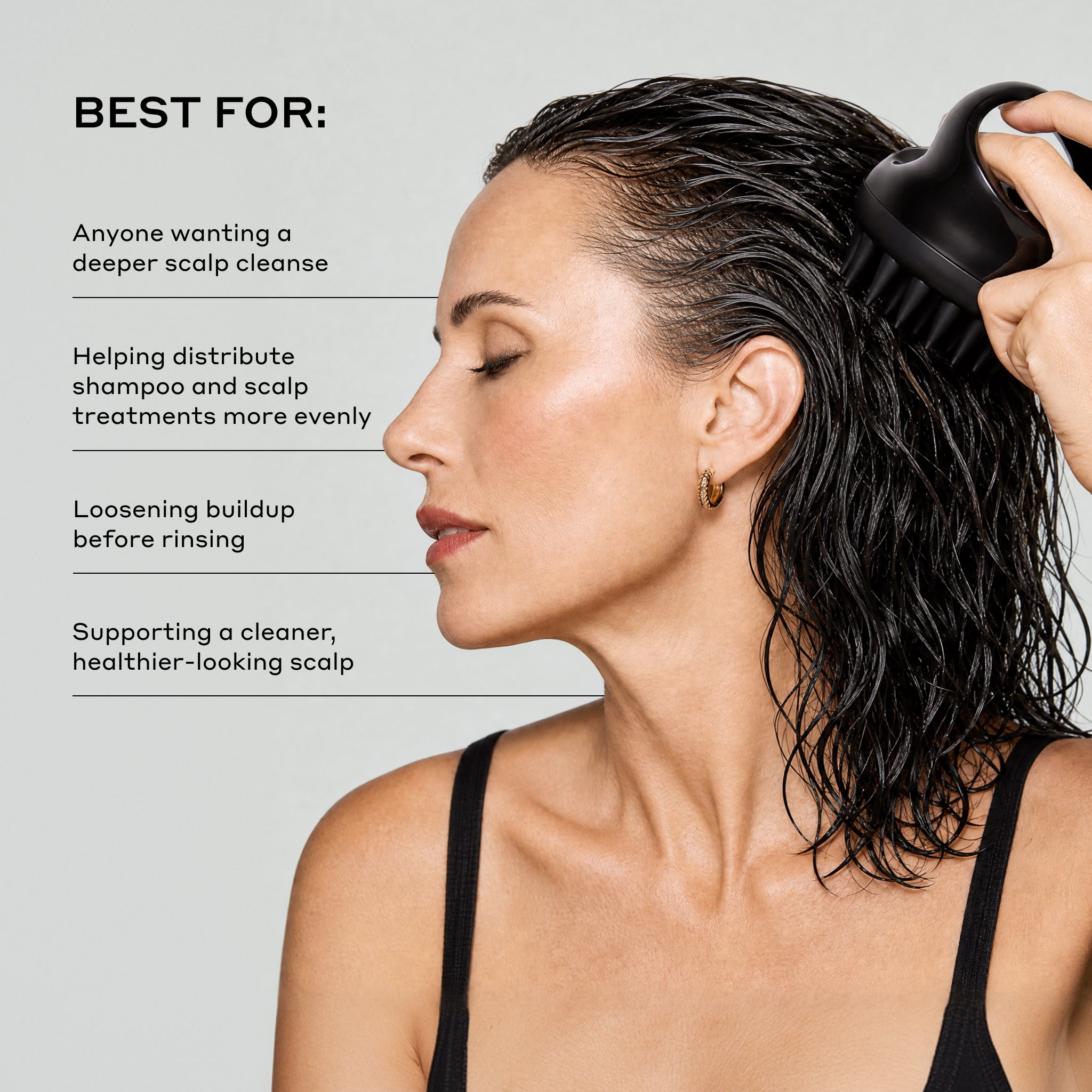 A woman with wet dark hair uses a black scalp cleansing brush against her scalp. Text on the left reads 'BEST FOR:' followed by benefits for scalp cleansing.