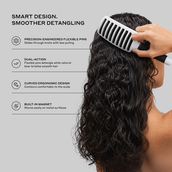 A hand uses a black and white detangling brush with flexible pins on long, dark curly hair. The left side features text highlighting product features like 'PRECISION-ENGINEERED FLEXIBLE PINS', 'DUAL-ACTION', and 'CURVED ERGONOMIC DESIGN' on a light gray background.